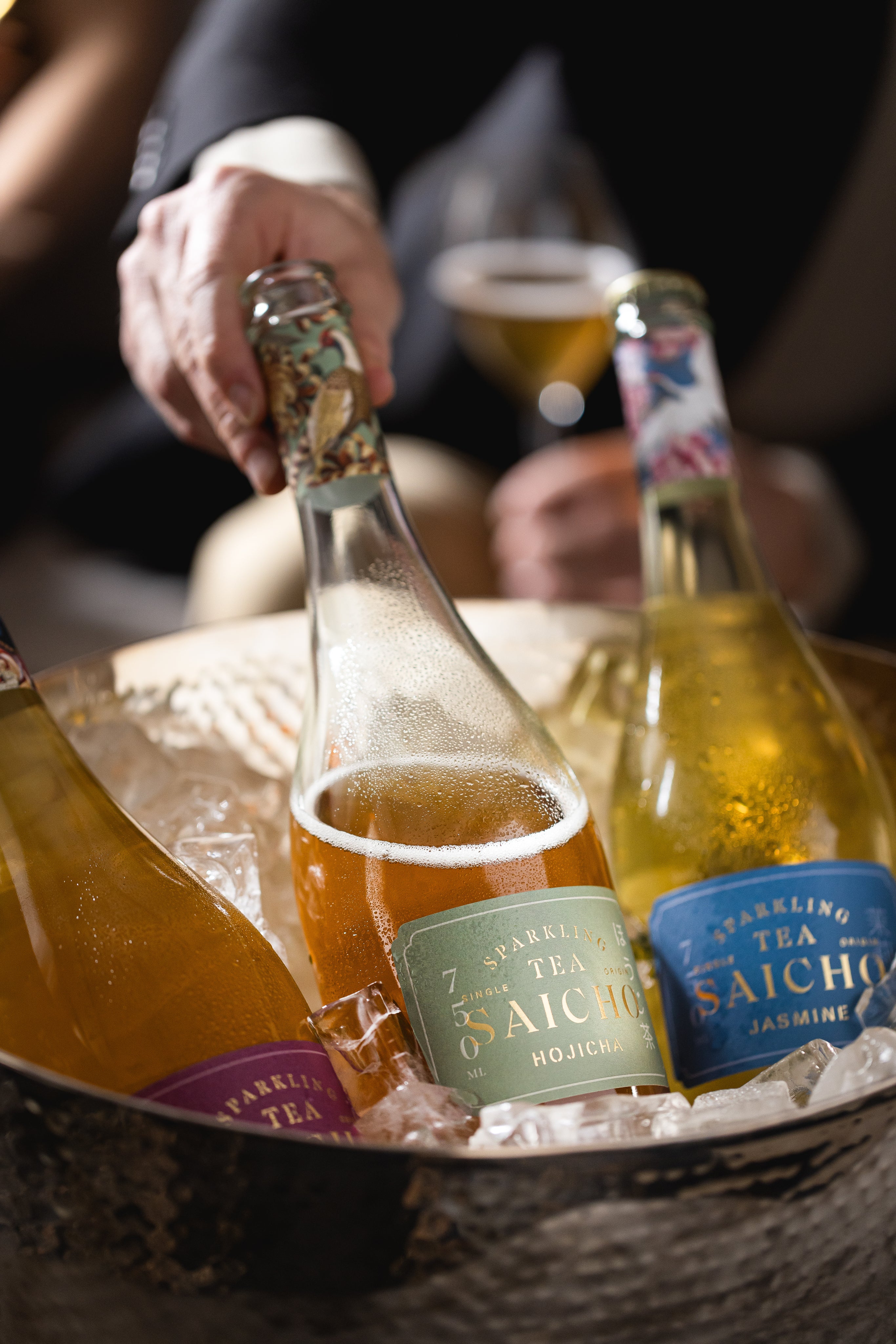 Four elegant Saicho sparkling tea bottles, showcasing Osmanthus, Darjeeling, Jasmine, and Hojicha varieties.